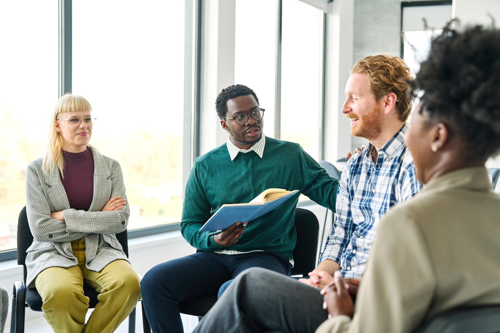 Man sits with a group talking
